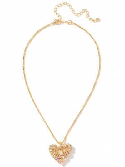 Crystal Heart Pendant Necklace - NGK2BGGGO - <p>Twenty-five individually set crystals form a delicate openwork heart suspended from a bright gold-tone box chain. The mix of warm champagne, soft silk, and vintage rose tones creates a subtle gradient of color that catches the light naturally as you move. The structured box chain keeps the pendant gracefully centered near your collarbone, while the extension chain lets you adjust the drop to accommodate varying necklines. It is a quiet, considered piece that feels instantly familiar.</p><ul>
<li>Intricate openwork heart design arranged from warm pink and champagne round-cut crystals</li>
<li>Fluid box chain construction offers a structured drape</li>
<li>Lobster claw clasp</li>
<li>4-inch adjustable extension chain</li>
<li>Protective e-coat finish for lasting wear</li>
<li>Includes signature organza pouch for gifting and travel</li>
</ul>