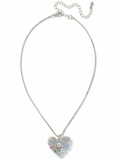 Crystal Heart Pendant Necklace - NGK2PDRQ - <p>Suspended from a fluid box chain, this open-work heart pendant balances precise geometry with a soft wash of color. The arrangement of pale blue, gentle rose, and iridescent crystals catches the light from multiple angles, shifting gently as you move through your day. The chain drapes smoothly across the collarbone, and the built-in extension allows you to adjust the drop. It brings a quiet, intentional presence to a simple silk blouse or a favorite knit sweater.</p><ul>
<li>Open-work heart silhouette formed by clustered mixed-scale crystals</li>
<li>Fluid box chain construction offers a smooth and continuous drape</li>
<li>Lobster claw clasp</li>
<li>4-inch adjustable extension chain</li>
<li>Protective e-coat finish for lasting wear</li>
<li>Includes signature organza pouch for gifting and travel</li>
</ul>