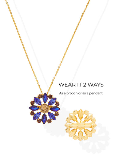 Blooming Brooch Pendant Necklace - NGK3BGDNM - <p>Radiant deep blue marquise crystals circle a warm champagne center in this versatile floral design. Suspended on a fine cable chain, the sunburst motif catches the light as you move. A hidden pin mechanism on the reverse allows you to remove the chain entirely, transforming the pendant into a standalone brooch to pin to a blazer lapel or a silk scarf. An included extension chain ensures the necklace falls exactly where you need it to complement your neckline.</p><ul>
<li>Convertible design functions as both a pendant necklace and a standalone pin</li>
<li>Alternating blue marquise crystals radiate from a warm central stone</li>
<li>Lobster claw clasp</li>
<li>4-inch adjustable extension chain</li>
<li>Protective e-coat finish for lasting wear</li>
<li>Includes signature organza pouch for gifting and travel</li>
</ul>