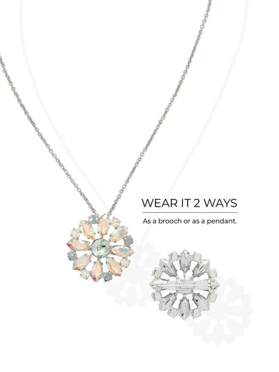 Blooming Brooch Pendant Necklace - NGK3PDRQ - <p>A central pale azore crystal anchors a radiating circle of marquise cut aurora borealis stones. Suspended from a fine cable chain, the floral motif catches subtle shifts in light with every movement. The one and a quarter inch scale offers distinct presence at the collarbone without feeling heavy. Designed with a convertible back mechanism, the piece easily transitions from a suspended pendant to a pinned lapel brooch. The included extension chain ensures precise placement for any neckline.</p><ul>
<li>Wearable as both a suspended pendant and a traditional lapel brooch</li>
<li>Alternating marquise and round crystals create a dimensional floral motif</li>
<li>Lobster claw clasp</li>
<li>4-inch adjustable extension chain</li>
<li>Protective e-coat finish for lasting wear</li>
<li>Includes signature organza pouch for gifting and travel</li>
</ul>