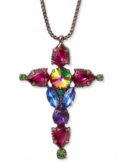 Contessa Cross Pendant Necklace - NGL2GMNNI - <p>Anchored by a long gunmetal box chain, this substantial cross pendant brings a grounded, architectural presence to your daily rotation. The design builds outward from a fiery central volcano crystal, branching into rich tones of fuchsia, deep burgundy, and blue zircon. Pear and marquise cuts create a structured shape that catches light in motion. The extended chain drops elegantly down the torso, offering a comforting weight that easily anchors a layered look or stands independently over a simple knit.</p><ul>
<li>Architectural cross design framed by contrasting pear and marquise stones</li>
<li>Suspended on a fluid dark metal box chain</li>
<li>Lobster claw clasp</li>
<li>4-inch adjustable extension chain</li>
<li>Includes organza pouch for gifting and travel</li>
</ul>