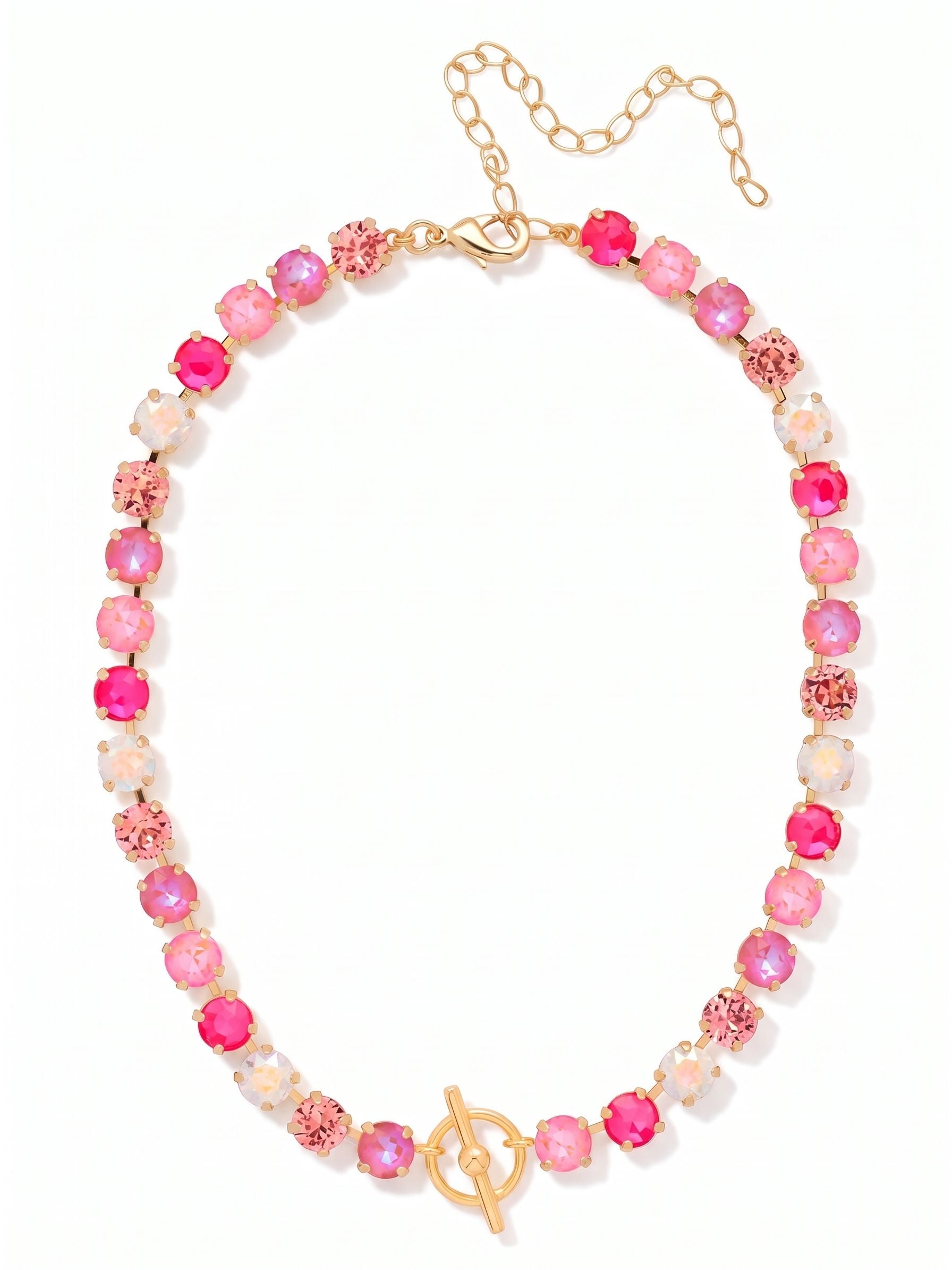 Matilda Toggle Tennis Necklace - NGM1BGPIN - <p>A line of light rose, electric pink, and iridescent round-cut crystals brings immediate warmth to the neckline. The classic tennis silhouette is anchored by a decorative gold-tone toggle that rests at the collarbone, creating a distinctive focal point. Built on a flexible kette chain, the piece drapes smoothly and moves comfortably as you wear it. Designed with an adjustable extension at the back, it layers easily over a silk top or sits neatly inside an open collar.</p><ul>
<li>Decorative front toggle creates a central focal point at the neckline</li>
<li>Vibrant mix of electric pink and iridescent aurora borealis crystals</li>
<li>Lobster claw clasp</li>
<li>4-inch adjustable extension chain</li>
<li>Protective e-coat finish for lasting wear</li>
<li>Includes organza pouch for gifting and travel</li>
</ul>