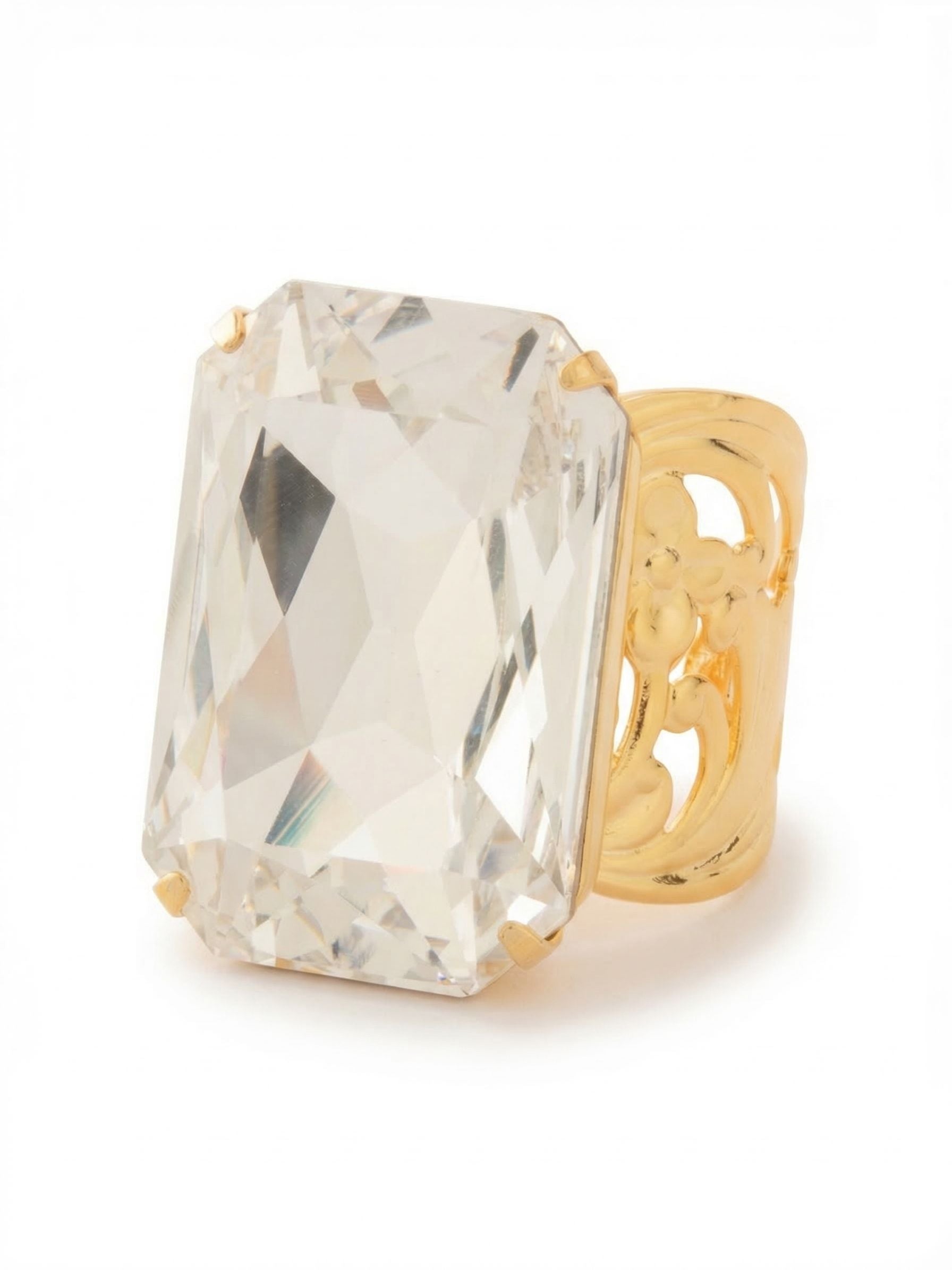 Viretta Adjustable Cocktail Ring - RBT67BGCRY - <p>A single oversized emerald cut crystal commands attention on the hand. Catching light with every natural movement, the faceted stone brings architectural presence to your daily wear. It sits on a wide band detailed with open floral metalwork, keeping the substantial piece feeling balanced and secure rather than heavy. Because the ring is adjustable, you have the flexibility to wear it on your index or middle finger, shifting the look seamlessly from daytime tailoring to an evening out.</p><ul>
<li>Oversized step faceted crystal that spans the finger</li>
<li>Wide openwork band with intricate floral metal details</li>
<li>Adjustable ring band</li>
<li>Protective e-coat finish for lasting wear</li>
<li>Includes signature organza pouch for gifting and travel</li>
</ul>