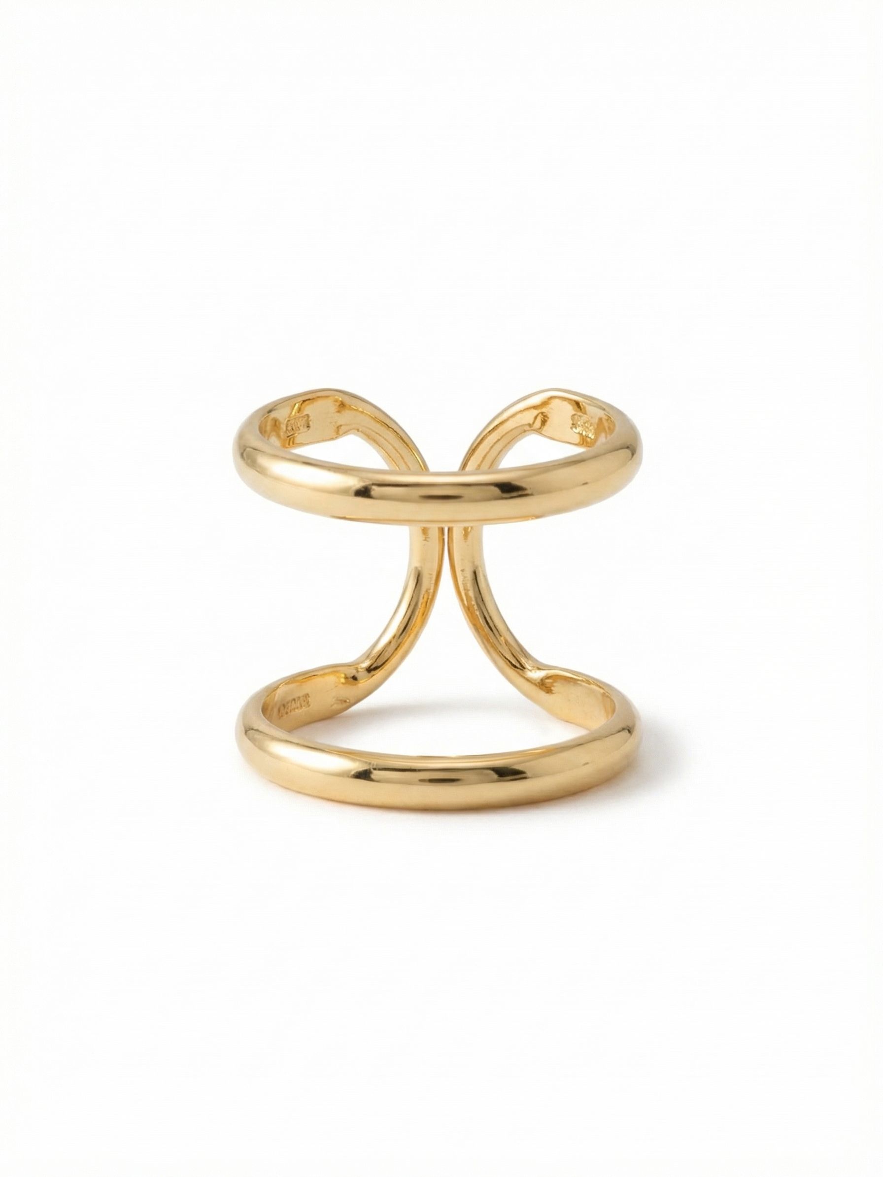 Running In Circles Stacked Ring - RDW3BGCRY - <p>The continuous curves of this gold-tone ring create the illusion of multiple bands stacked together. It takes up substantial space on the hand while remaining completely weightless, letting your skin show through the sculptural negative space. The open, fluid architecture is designed to flex slightly, giving you a comfortable fit that adapts to your day. It is an architectural everyday piece that stands entirely on its own.</p><ul>
<li>Continuous sculptural design creates a double-band stacked effect</li>
<li>Airy openwork structure highlights negative space on the finger</li>
<li>Adjustable ring band</li>
<li>Protective e-coat finish for lasting wear</li>
<li>Includes signature organza pouch for gifting and travel</li>
</ul>