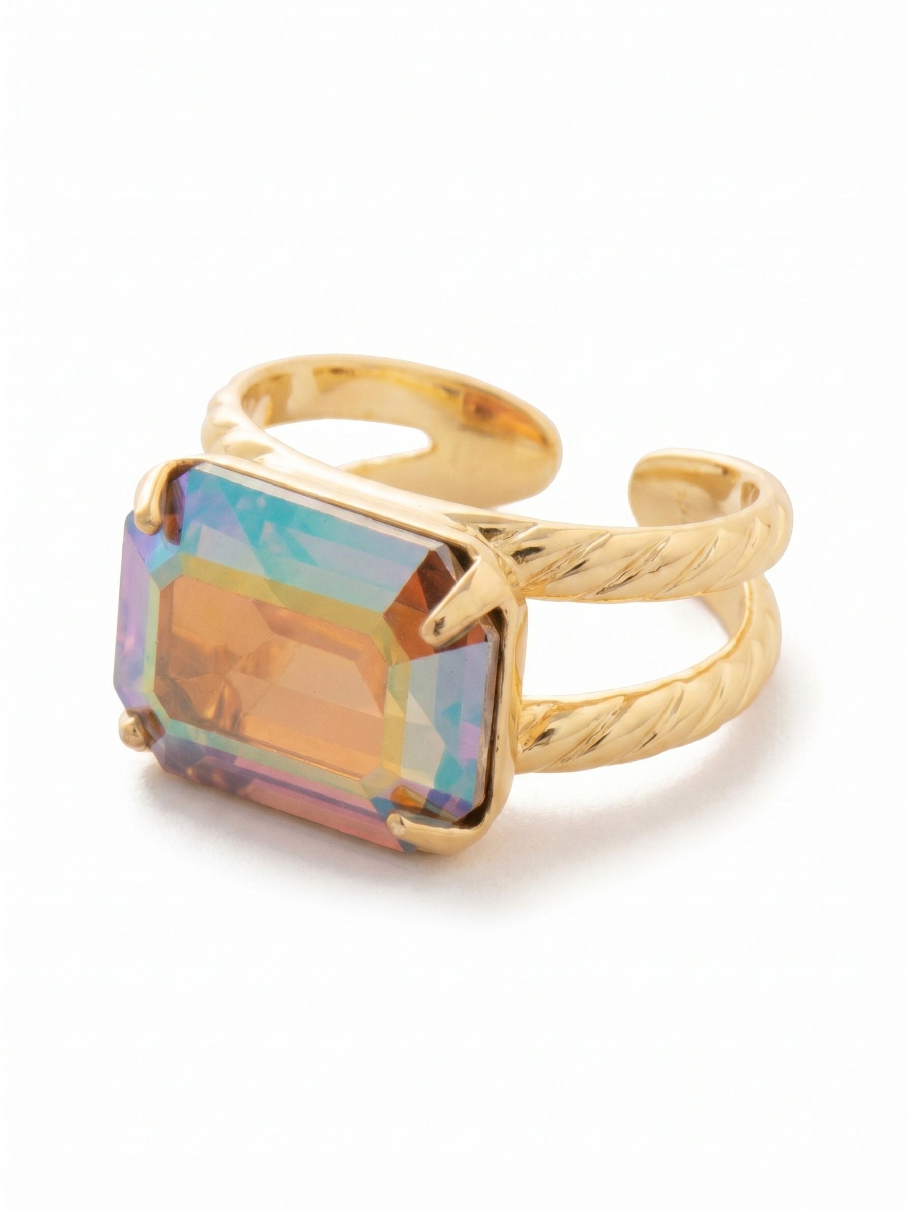 Emerald Cocktail Ring - RFL88BGLCA - <p>This cocktail ring centers a single, substantial emerald-cut crystal, set horizontally across the finger. The stone's iridescent finish shifts between warm amber and cool teal as your hand moves through the day. Secured by a split band with a subtle rope texture, the open-back design allows for slight adjustments so you can find a comfortable, secure fit on any finger. It offers noticeable presence without feeling heavy, making it an easy companion for an evening out or a long dinner.</p><ul>
<li>Horizontally oriented crystal for an east-west profile</li>
<li>Split band with a tactile twisted rope texture</li>
<li>Adjustable ring band</li>
<li>Protective e-coat finish for lasting wear</li>
<li>Includes signature organza pouch for gifting and travel</li>
</ul>