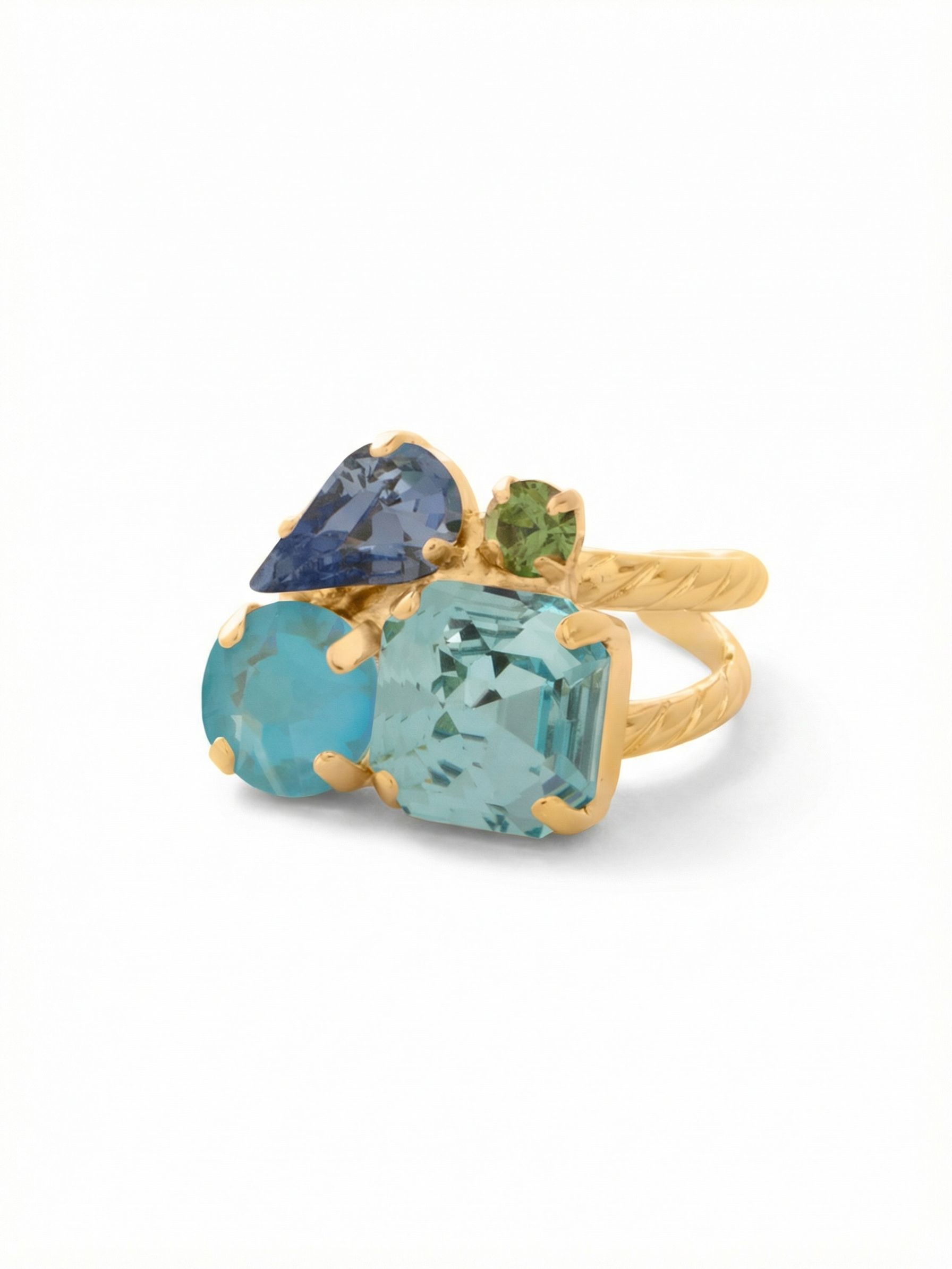Anika Adjustable Cocktail Ring - RFY11BGOC - <p>Four distinct crystal shapes gather in an asymmetrical cluster, catching the light as you talk with your hands or reach for a coffee cup. A structured aquamarine square anchors the arrangement, softened by shifting tones of blue and a tiny pop of peridot green. This interplay of color and cut creates a fluid visual rhythm. The open, rope-textured band gives you the flexibility to easily adjust the fit or move the piece between fingers throughout the week.</p><ul>
<li>Asymmetrical cluster of contrasting mixed crystal shapes</li>
<li>Cool aquatic palette anchored by a structured square profile</li>
<li>Adjustable ring band</li>
<li>Protective e-coat finish for lasting wear</li>
<li>Includes signature organza pouch for gifting and travel</li>
</ul>
