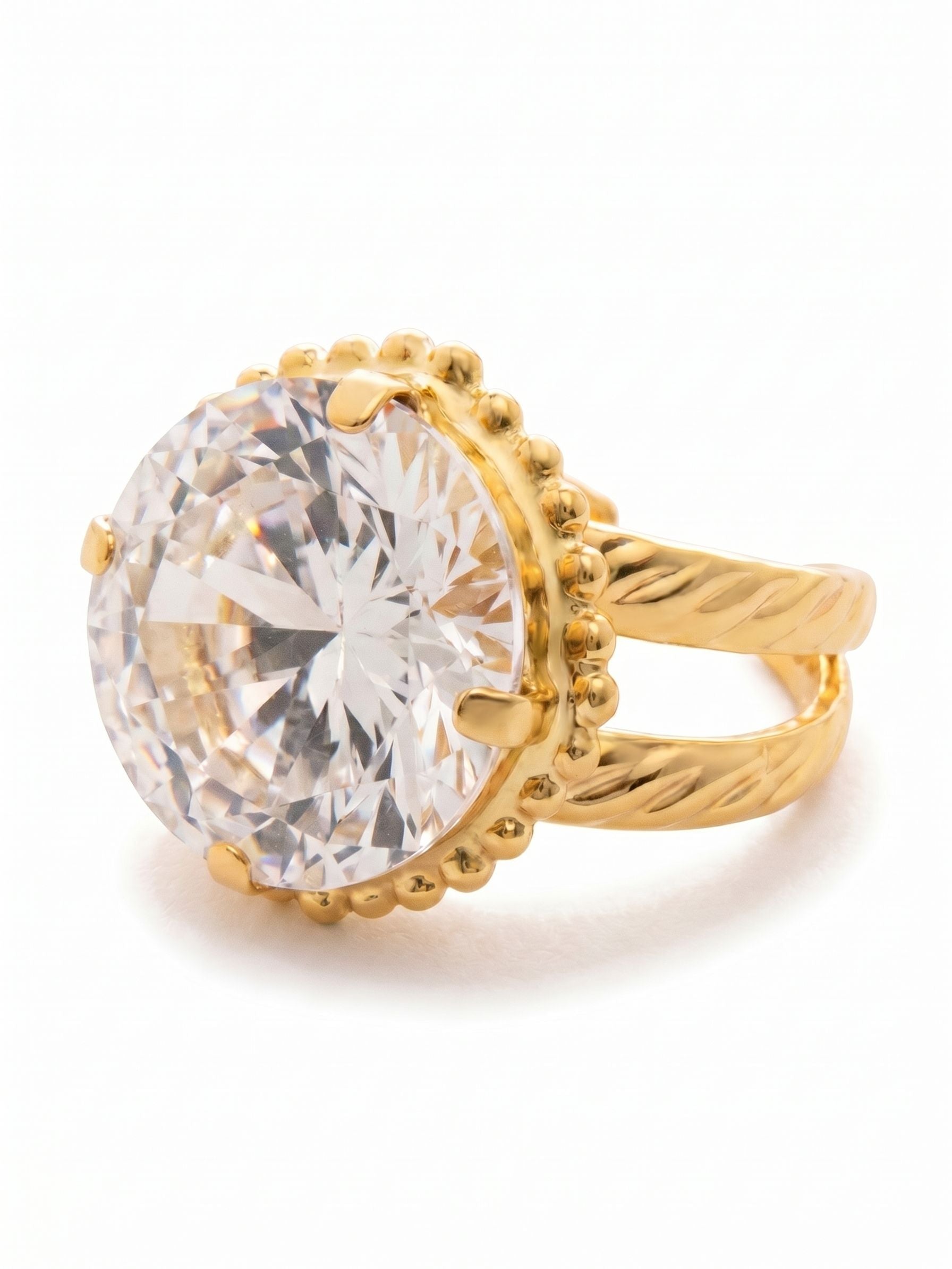 Noor Cocktail Ring - RFZ44BGCRY - <p>An oversized clear crystal anchors this classic cocktail ring. The round-cut stone catches light with every gesture of your hand, framed by a setting with delicate beaded accents. A split, twisted band adds rich texture from the side while keeping the overall feel surprisingly light. The open design allows you to easily adjust the fit, giving you the freedom to move the piece between fingers as your day or the seasons change.</p><ul>
<li>A single oversized round-cut crystal framed by delicate beaded texturing</li>
<li>Split band design with a twisted metal texture for side visual interest</li>
<li>Adjustable ring band</li>
<li>Protective e-coat finish for lasting wear</li>
<li>Includes signature organza pouch for gifting and travel</li>
</ul>