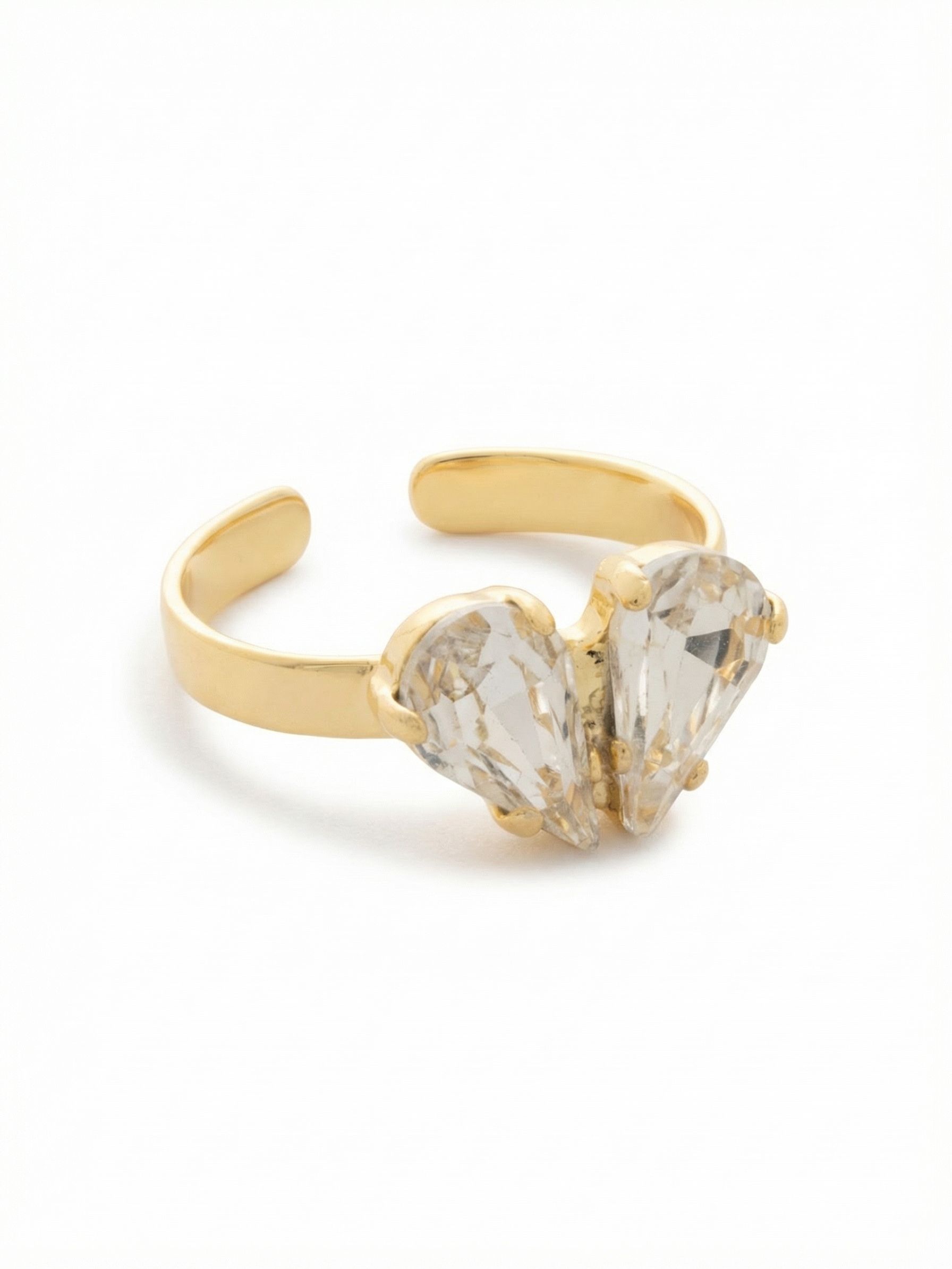 Marlowe Cocktail Ring - RGF2BGCRY - <p>Two faceted pear-cut crystals sit side by side on the front of this ring, their rounded tops meeting at the center and their points angled outward and down to form a soft heart. The light catches each pear from a different angle as your hand moves, so the heart shimmers rather than sits still. The smooth metal band has a subtle opening at the back, giving you the flexibility to gently adjust the size.</p><ul>
<li>Two faceted pear-cut crystals arranged tip-to-tip to form a heart silhouette across the finger</li>
<li>Smooth band profile that highlights the faceted center stones</li>
<li>Adjustable ring band</li>
<li>Protective e-coat finish for lasting wear</li>
<li>Includes signature organza pouch for gifting and travel</li>
</ul>