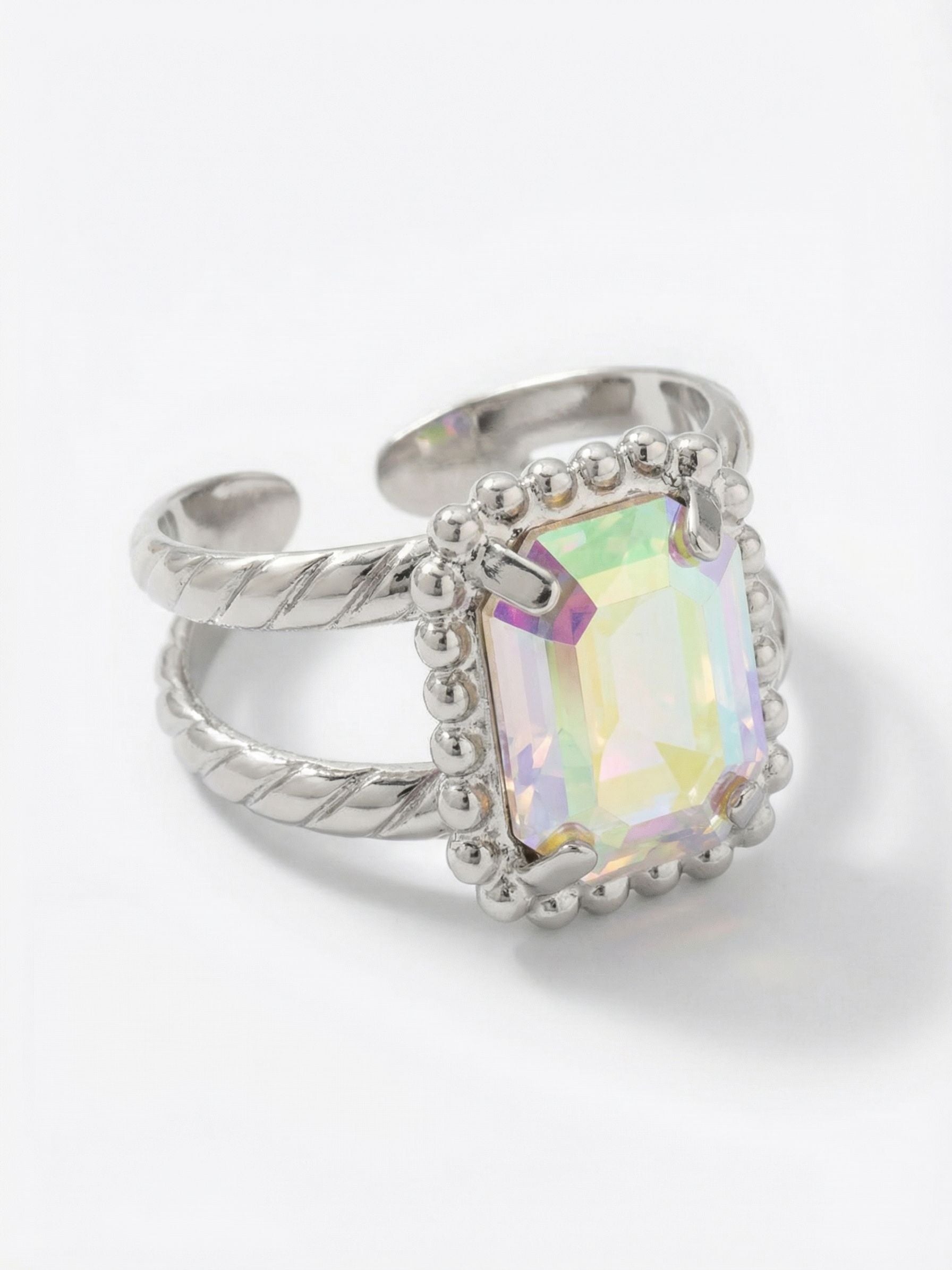 Octavia Scalloped Stacked Ring - RGK1PDCAB - <p>A single emerald-cut crystal acts as a prism on the hand, shifting in color as you type or reach for a glass. The stone rests securely within a detailed beaded setting that adds a quiet textural contrast to the smooth facets. Designed to look like two twisted rings, the double band offers the illusion of a stack with the ease of a single piece. The open back design allows you to customize the fit for lasting comfort.</p><ul>
<li>Intricately beaded metal setting framing an emerald-cut crystal</li>
<li>Twisted double band creates the illusion of a stacked look</li>
<li>Adjustable ring band</li>
<li>Protective e-coat finish for lasting wear</li>
<li>Includes signature organza pouch for gifting and travel</li>
</ul>