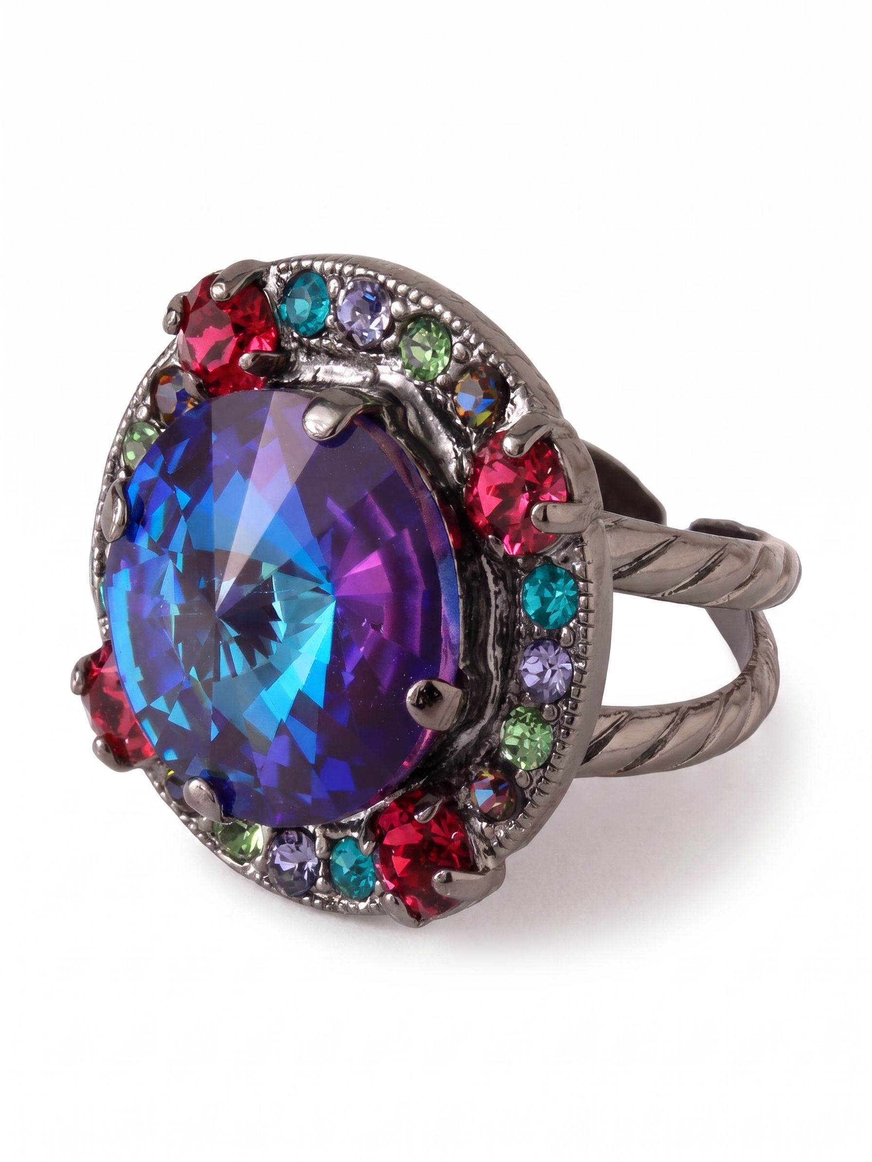 Nova Adjustable Cocktail Ring - RGL4GMNNI - <p>A large, color-shifting crystal anchors this ring, flashing deep blues and purples with every gesture. A tight halo of vivid stones frames the center, catching light in a spectrum of bright jewel tones. The dark metal setting grounds these vibrant colors, while the textured split-shank band provides substantial weight and structural balance. An open back lets you adjust the fit exactly how you prefer, offering a firm, comfortable hold.</p><ul>
<li>Textured split-shank band provides visual weight and balance</li>
<li>Multicolor crystal halo creates an unexpected spectrum of light</li>
<li>Adjustable ring band</li>
<li>Includes organza pouch for gifting and travel</li>
</ul>