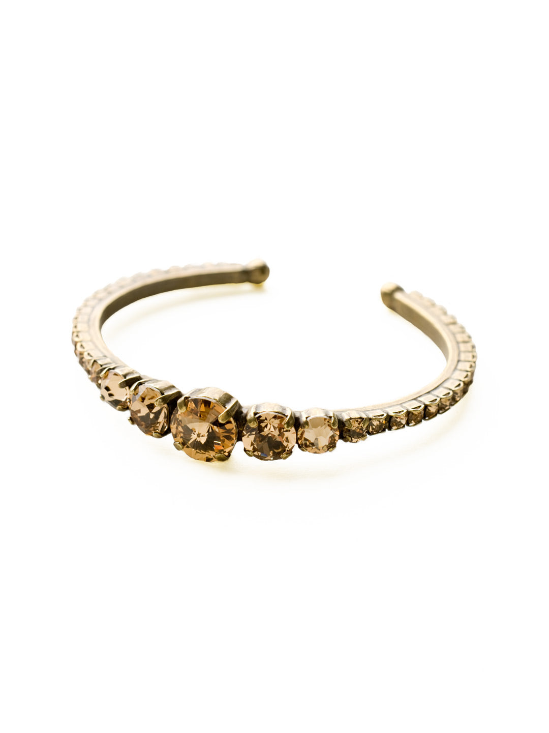 Dazzling Dotted Line Cuff Bracelet - BCQ14AGNT - <p>This cuff bracelet is pretty and petite yet packed with sparkle! Multi-sized round crystals cover this bracelet from end to end. Add this beauty to your current arm party or wear alone for a subtle statement. From Sorrelli's Neutral Territory collection in our Antique Gold-tone finish.</p>