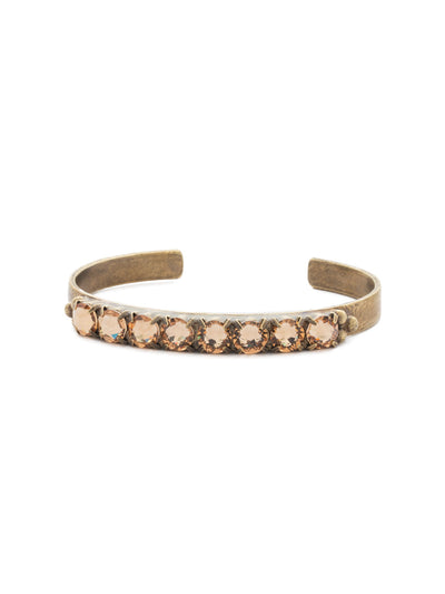 Mesmerizing Round Crystal Cuff - BDG8AGNT - <p>A beautiful halo of round cut crystals with brass detail adorns this simple, elegant cuff. Metal ball elements give added texture to the overall design. From Sorrelli's Neutral Territory collection in our Antique Gold-tone finish.</p>