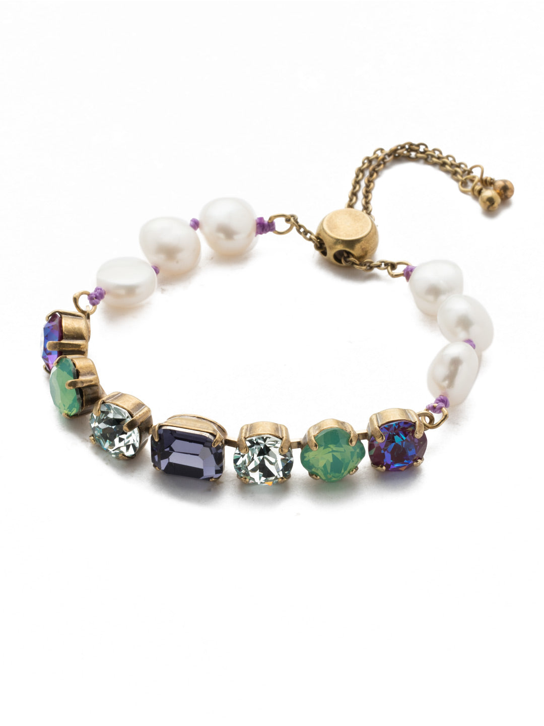 Cadenza Slider Bracelet - BEC14AGIRB - A classic line bracelet reimagined with a adjustable slider clasp. A pattern of crystals and pearls give this bracelet all around allure. From Sorrelli's Iris Bloom collection in our Antique Gold-tone finish.