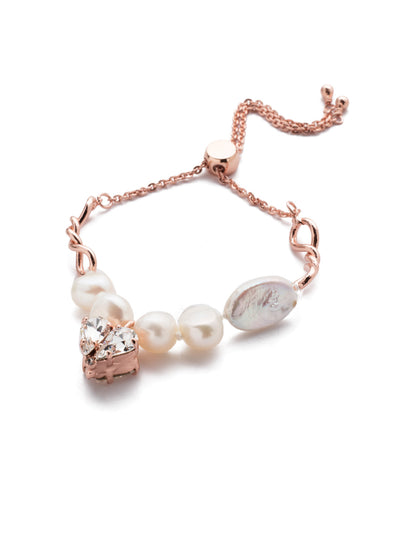 Venus Slider Bracelet - BER10RGCRY - <p>A mix of edgy and classy, that's the Venus Slider Bracelet. Fun twists of metal give way to timeless freshwater pearls before capping of at the center with a sparkling crystal heart. From Sorrelli's Crystal collection in our Rose Gold-tone finish.</p>