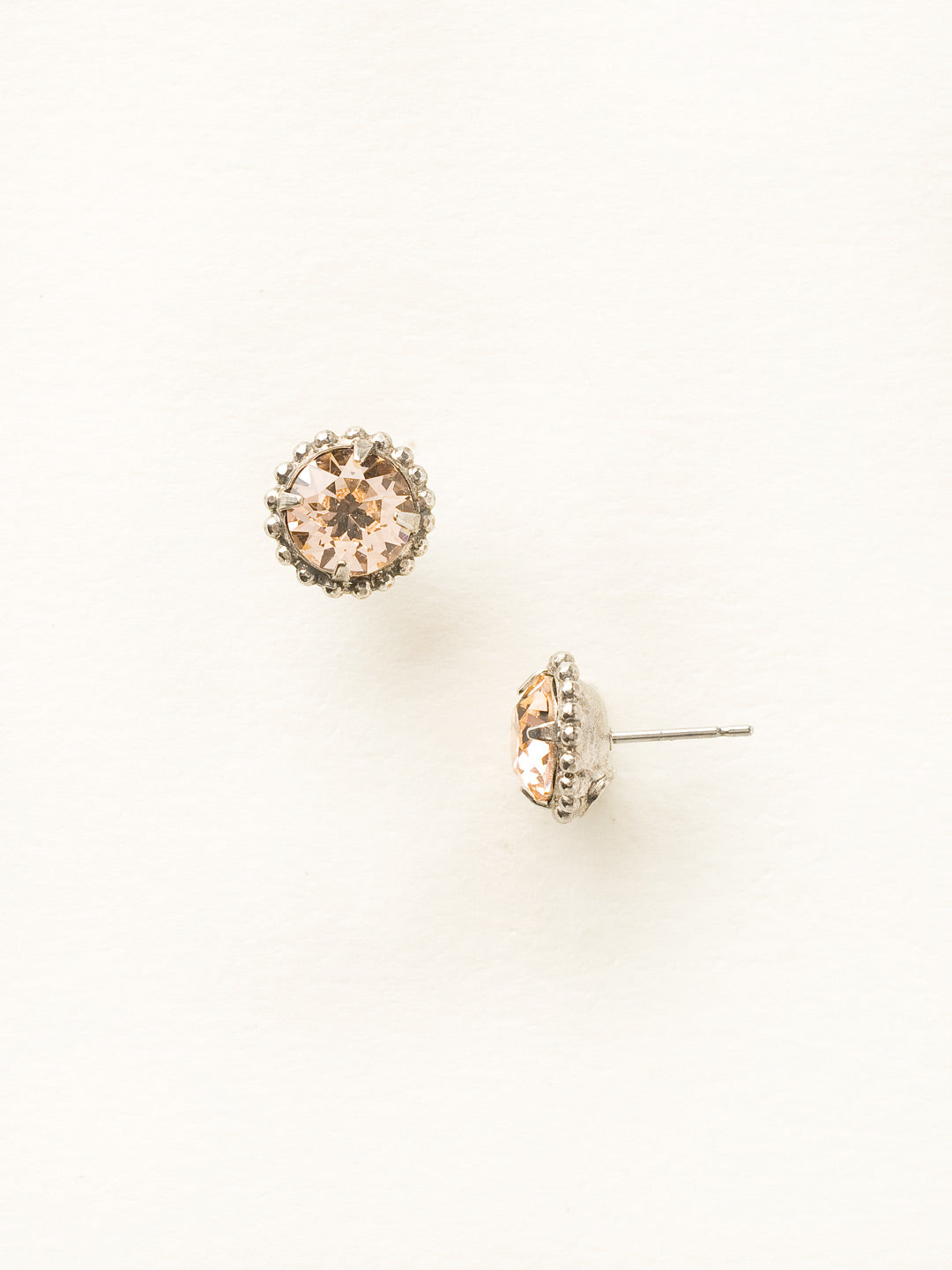 Simplicity Stud Earrings - EBY38ASLPE - <p>A timeless classic, the Simplicity Stud Earrings feature round cut crystals in a variety of colors; accented with a halo of metal beaded detail. Need help picking a stud? <a href="https://www.sorrelli.com/blogs/sisterhood/round-stud-earrings-101-a-rundown-of-sizes-styles-and-sparkle">Check out our size guide!</a> From Sorrelli's Light Peach collection in our Antique Silver-tone finish.</p>