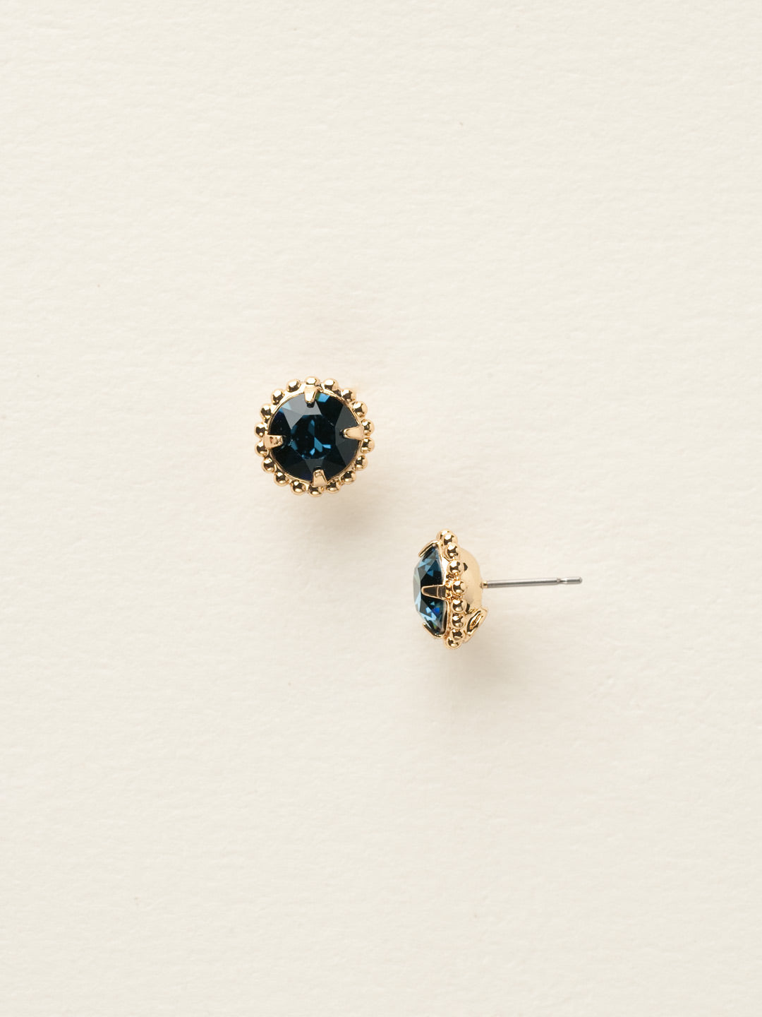 Simplicity Stud Earrings - EBY38BGMON - <p>A timeless classic, the Simplicity Stud Earrings feature round cut crystals in a variety of colors; accented with a halo of metal beaded detail. Need help picking a stud? <a href="https://www.sorrelli.com/blogs/sisterhood/round-stud-earrings-101-a-rundown-of-sizes-styles-and-sparkle">Check out our size guide!</a> From Sorrelli's Montana collection in our Bright Gold-tone finish.</p>