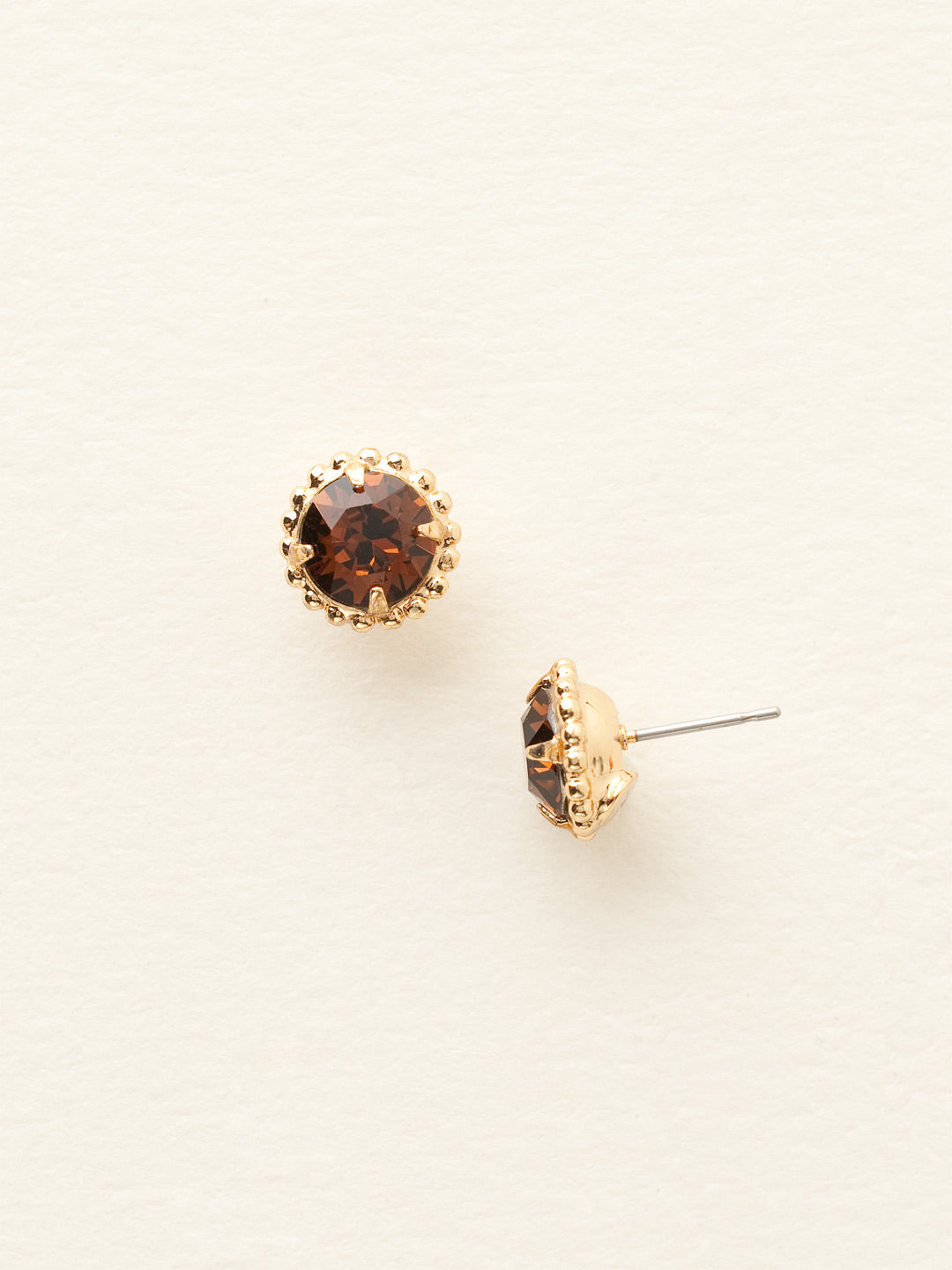 Simplicity Stud Earrings - EBY38BGSMT - <p>A timeless classic, the Simplicity Stud Earrings feature round cut crystals in a variety of colors; accented with a halo of metal beaded detail. Need help picking a stud? <a href="https://www.sorrelli.com/blogs/sisterhood/round-stud-earrings-101-a-rundown-of-sizes-styles-and-sparkle">Check out our size guide!</a> From Sorrelli's Smoke Topaz collection in our Bright Gold-tone finish.</p>