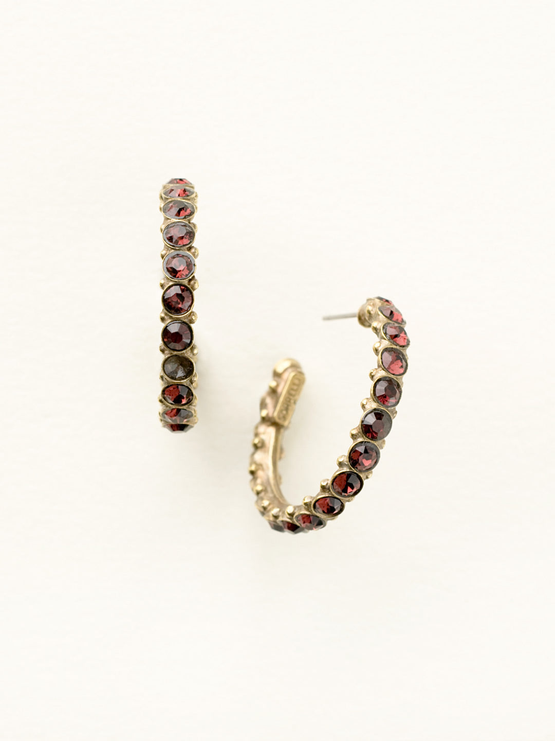 Heavenly Hoop Earrings - ECQ24AGSAN - <p>Gemstones cover the outside of these hoop earrings. Their simple style combined with the sparkle of the jewels makes it the perfect staple piece for your jewelry box. From Sorrelli's Sangria collection in our Antique Gold-tone finish.</p>