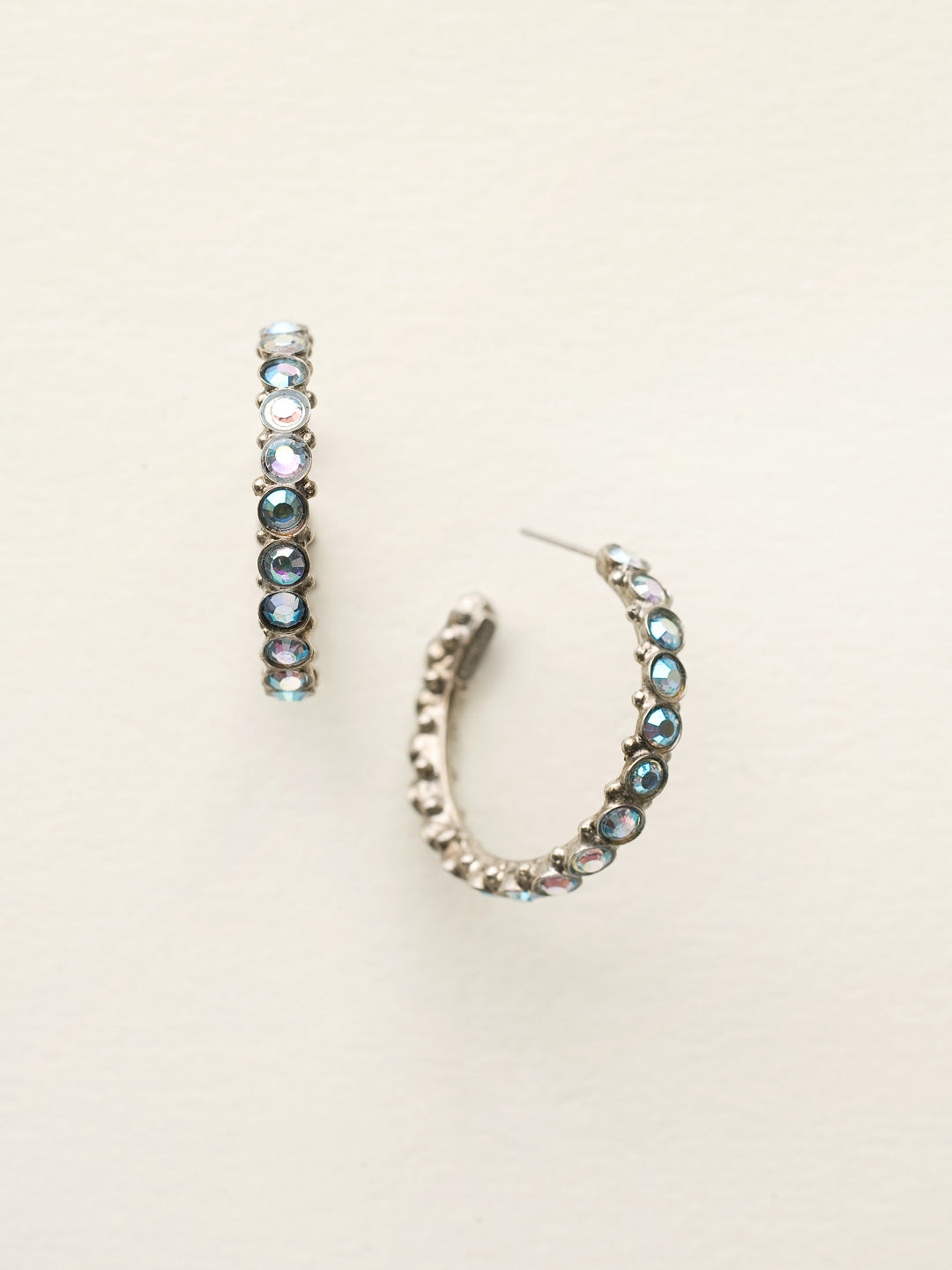 Heavenly Hoop Earrings - ECQ24ASIB - <p>Gemstones cover the outside of these hoop earrings. Their simple style combined with the sparkle of the jewels makes it the perfect staple piece for your jewelry box. From Sorrelli's Ice Blue collection in our Antique Silver-tone finish.</p>
