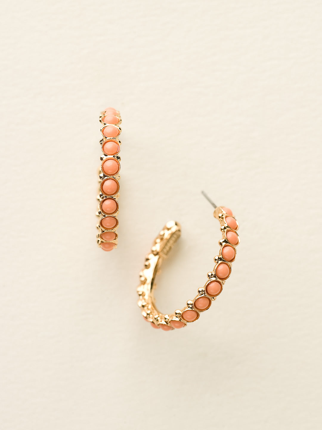 Heavenly Hoop Earrings - ECQ24BGCCO - <p>Gemstones cover the outside of these hoop earrings. Their simple style combined with the sparkle of the jewels makes it the perfect staple piece for your jewelry box. From Sorrelli's Caribbean Coral collection in our Bright Gold-tone finish.</p>