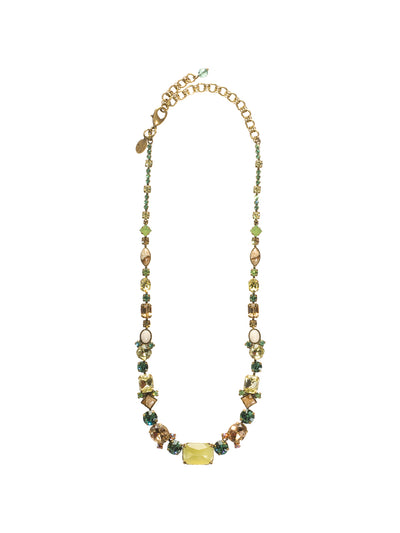 Center of Attention Tennis Necklace - NCF9AGWL - This classic line necklace features a central emerald cut crystal flanked by a mix of crystals and cabochons in oval, square and round cuts. Classic style with all -around allure! From Sorrelli's Water Lily collection in our Antique Gold-tone finish.