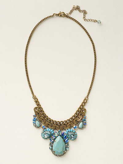 Graduated Pear Statement Necklace - NCU17AGAZ - Metal and sparkle have never looked so good! Five variously sized teardrop stones accented with feathered marquis crystals hang from a thick curb chain. From Sorrelli's Azure Allure collection in our Antique Gold-tone finish.
