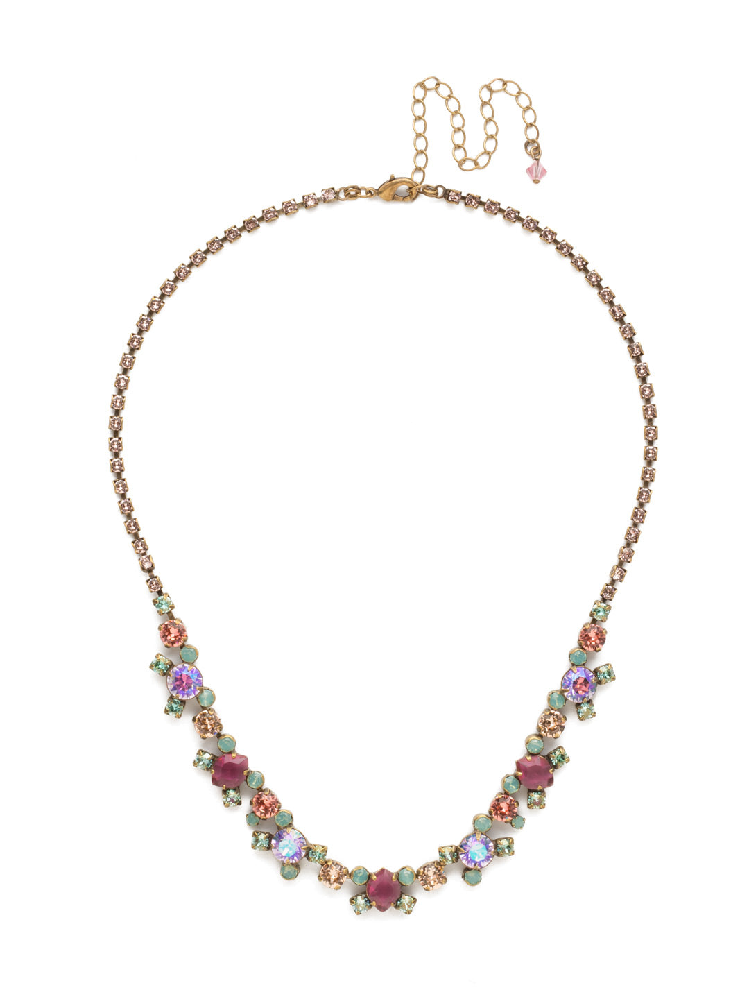 Perfect Harmony Line Tennis Necklace - NDK11AGRS - This classic line necklace features stations of crystal clusters alternating between round cut and pear shaped central stones, blending in perfect harmony! A rhinestone chain completes this design with all around sparkle. From Sorrelli's Radiant Sunrise collection in our Antique Gold-tone finish.