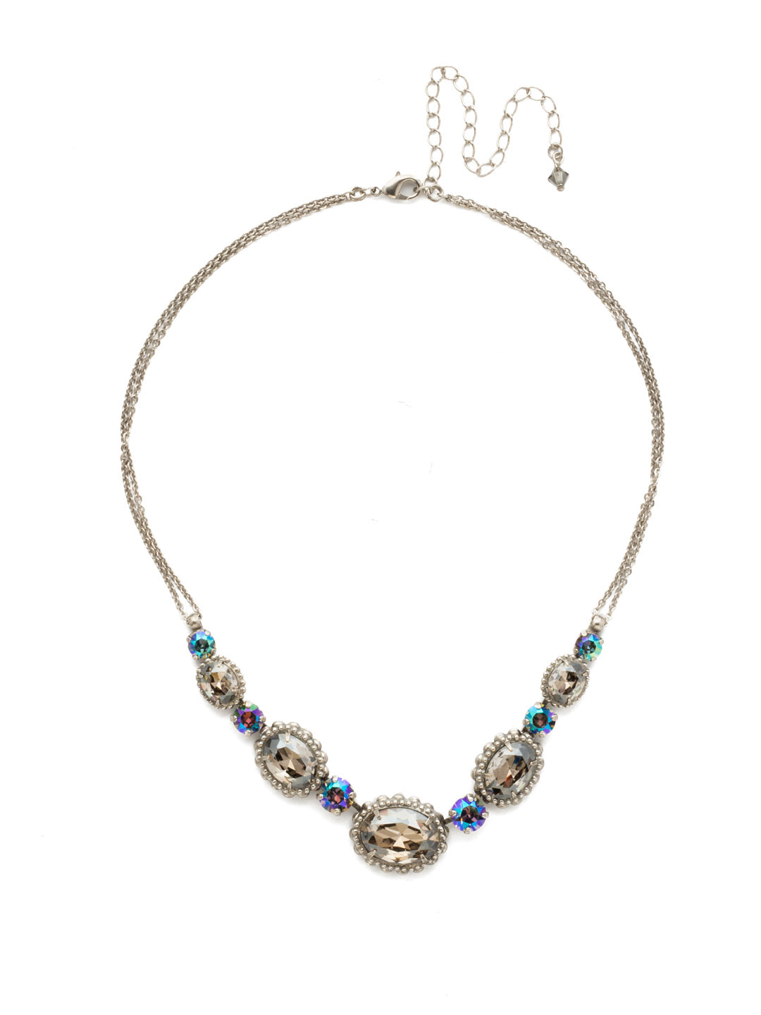 Camellia Necklace - NDQ10ASCRO - A delicate double chain adds subtle detail to this charming style. Five oval crystals with decorative metal edging are highlighted by petite round stones for a dynamic, dazzling look. From Sorrelli's Crystal Rock collection in our Antique Silver-tone finish.
