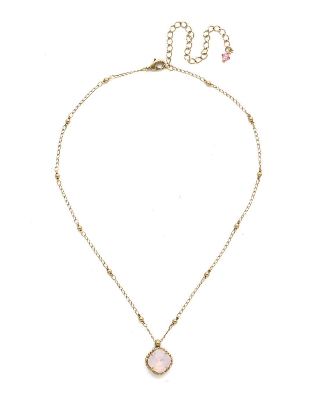 Cushion-Cut Pendant Necklace - NDS50AGROW - <p>Elevate your jewelry collection with this artisanally handcrafted pendant necklace. The solitaire 12mm cushion cut crystal is surrounded by a beautifully scalloped edge, creating a unique and eye-catching design. The little ball details along the chain add a touch of character. This adjustable necklace features a 16 inch chain with a 4 inch extension, complete with a delicate charm, for a versatile fit. Whether you're looking for a special gift or a treat for yourself, this handcrafted necklace is a stylish and timeless choice. From Sorrelli's Rose Water collection in our Antique Gold-tone finish.</p>