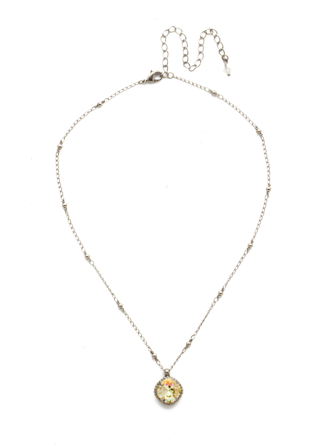 Cushion-Cut Pendant Necklace - NDS50ASCCH - <p>Elevate your jewelry collection with this artisanally handcrafted pendant necklace. The solitaire 12mm cushion cut crystal is surrounded by a beautifully scalloped edge, creating a unique and eye-catching design. The little ball details along the chain add a touch of character. This adjustable necklace features a 16 inch chain with a 4 inch extension, complete with a delicate charm, for a versatile fit. Whether you're looking for a special gift or a treat for yourself, this handcrafted necklace is a stylish and timeless choice. From Sorrelli's Crystal Champagne collection in our Antique Silver-tone finish.</p>