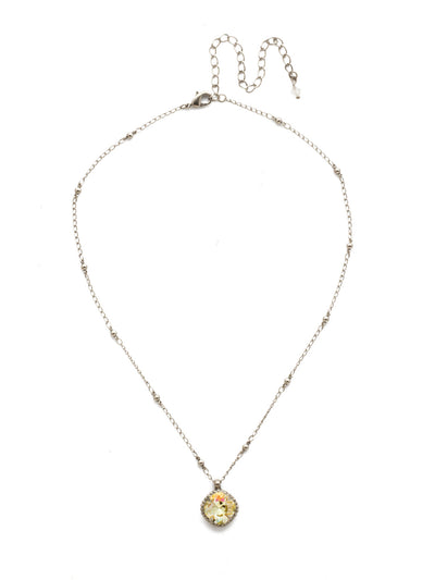 Cushion-Cut Pendant Necklace - NDS50ASCCH - <p>Elevate your jewelry collection with this artisanally handcrafted pendant necklace. The solitaire 12mm cushion cut crystal is surrounded by a beautifully scalloped edge, creating a unique and eye-catching design. The little ball details along the chain add a touch of character. This adjustable necklace features a 16 inch chain with a 4 inch extension, complete with a delicate charm, for a versatile fit. Whether you're looking for a special gift or a treat for yourself, this handcrafted necklace is a stylish and timeless choice. From Sorrelli's Crystal Champagne collection in our Antique Silver-tone finish.</p>