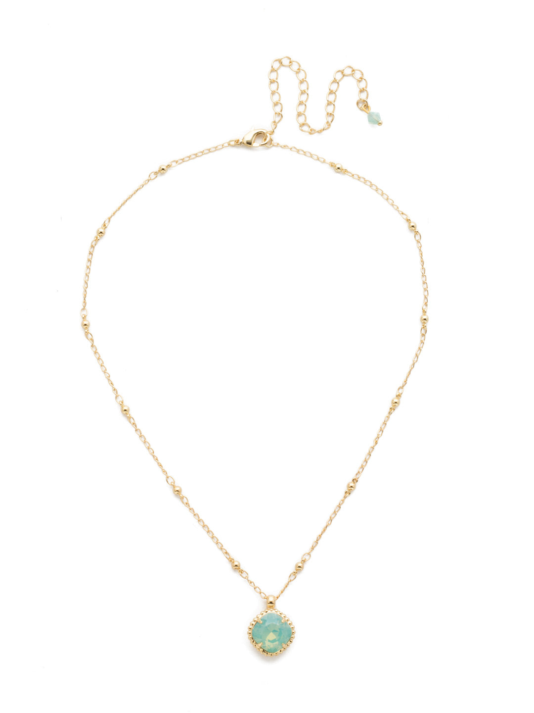 Cushion-Cut Pendant Necklace - NDS50BGPAC - <p>Elevate your jewelry collection with this artisanally handcrafted pendant necklace. The solitaire 12mm cushion cut crystal is surrounded by a beautifully scalloped edge, creating a unique and eye-catching design. The little ball details along the chain add a touch of character. This adjustable necklace features a 16 inch chain with a 4 inch extension, complete with a delicate charm, for a versatile fit. Whether you're looking for a special gift or a treat for yourself, this handcrafted necklace is a stylish and timeless choice. From Sorrelli's Pacific Opal collection in our Bright Gold-tone finish.</p>