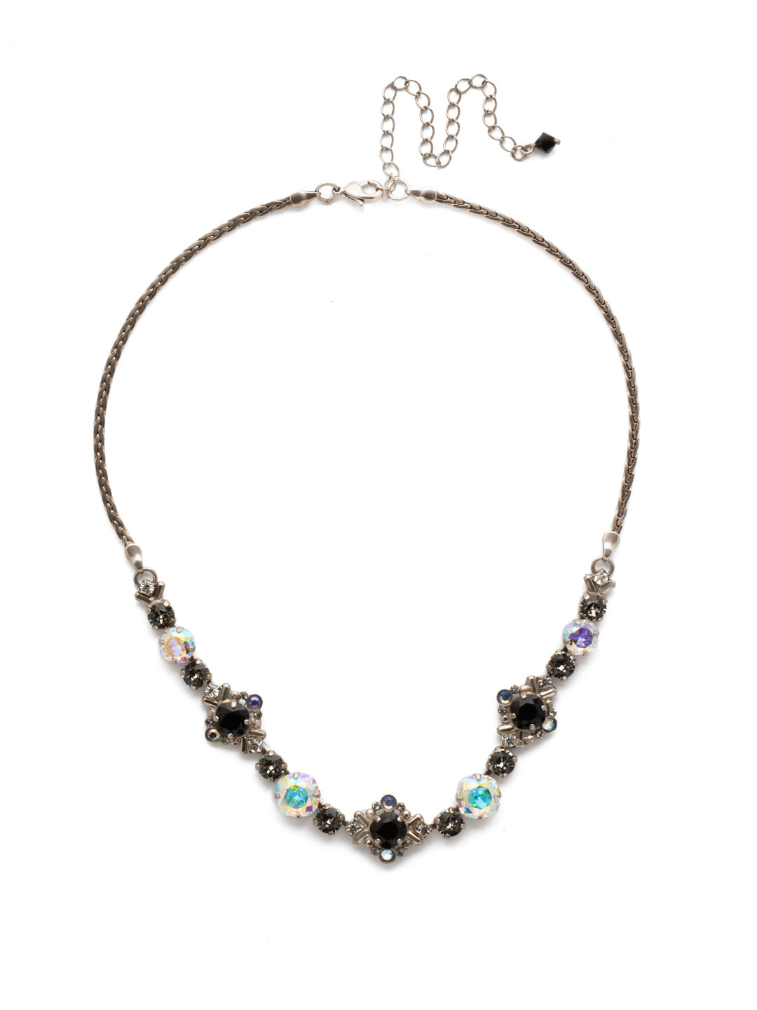 Stonecrop Tennis Necklace - NDX4ASBLT - A cushion cut stone in a detailed metal setting alternates with single round and cushion cut crystals in this dazzling half line necklace. From Sorrelli's Black Tie collection in our Antique Silver-tone finish.
