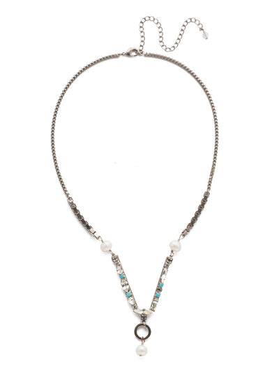 Aryana Necklace - NEC6ASPLP - A modern must-have! This classic line necklace showcases a geometric design with unique box chain and a central structured crystal element. Finished by a metal circle charm. From Sorrelli's Polished Pearl collection in our Antique Silver-tone finish.
