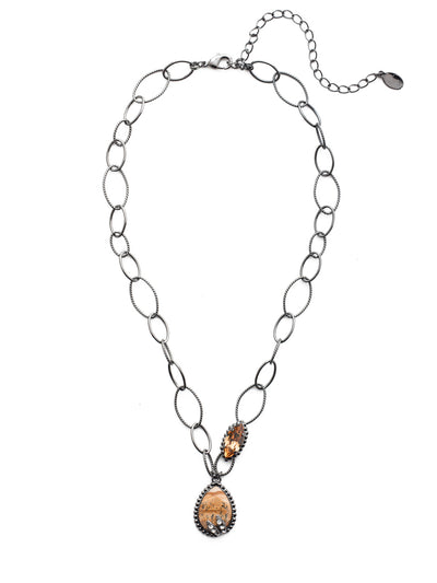 Forrest Pendant Necklace - NEU10GMGNS - Our Forrest Pendant Necklace showcases loops of airy metalwork, a sparkling marquise-shaped crystal and an earthy mineral stone enhanced with just a touch of bling. 'Tis always the season to treat yourself to something fabulous. From Sorrelli's Golden Shadow collection in our Gun Metal finish.