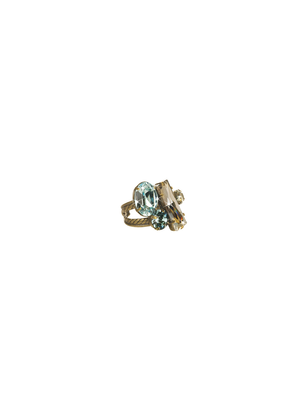 Abstract Cluster Ring - RCF54AGAFG - Available in a variety of colors, this ring showcases abstraction at its finest. Baguette, oval and round cut stones are clustered together at the front and center of this ring and sit atop an double rope designed adjustable band. Exudes style with every angle. From Sorrelli's Afterglow collection in our Antique Gold-tone finish.