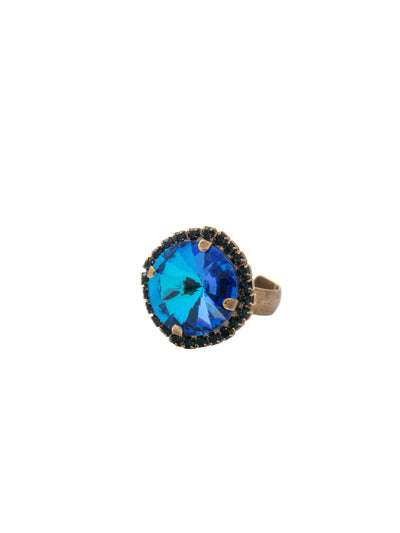 Giselle Round Cocktail Ring - RFC82AGVBN - <p>The Giselle Round Cocktail Ring features a round halo cut crystal on an adjustable band. From Sorrelli's Venice Blue collection in our Antique Gold-tone finish.</p>
